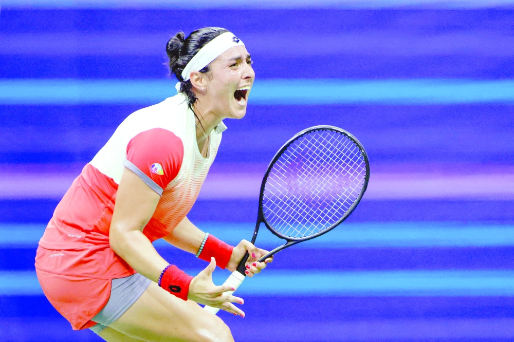Tunisia's Ons Jabeur celebrates after winning against France's Caroline Garcia during their 2022 US Open Tennis tournament women's singles semifinal match at the USTA Billie Jean King National Tennis Center in New York, on September 8, 2022. (Photo by KENA BETANCUR / AFP)