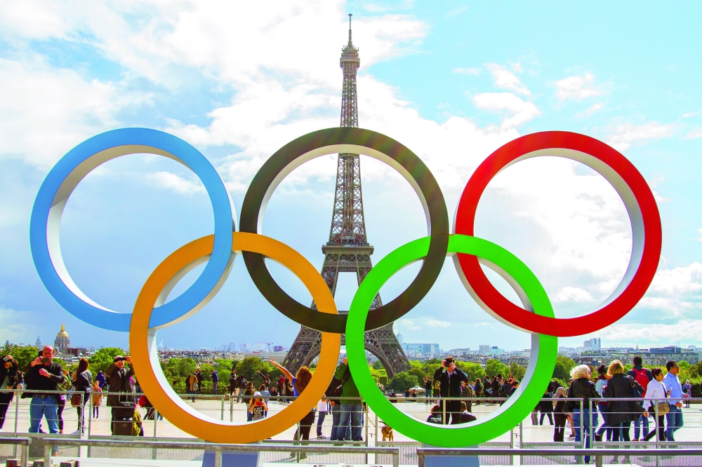 The Olympic Rings being placed in front of the Eiffel Tower