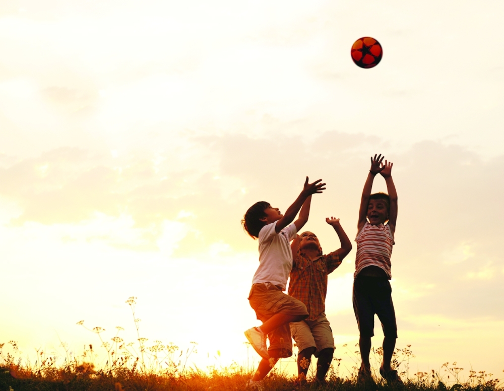 Group,Of,Happy,Children,Playing,With,Ball,On,Meadow,,Sunset,
