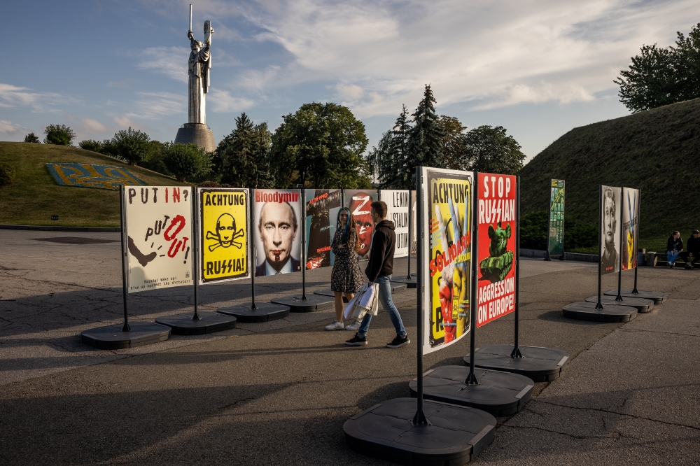 Signs against Russian President Vladimir Putin are seen in Kyiv, Ukraine, on Sunday, Sept. 11, 2022. (Jim Huylebroek/The New York Times)