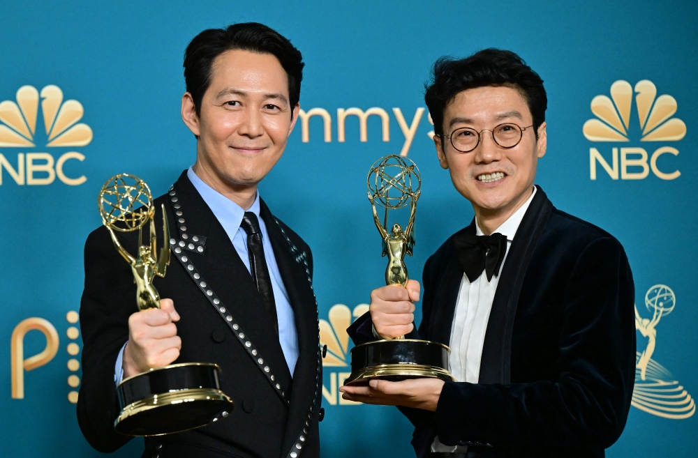 South Korean actor Lee Jung-jae (L) poses with the award for Outstanding Lead Actor In A Drama Series and South Korean director Hwang Dong-hyuk (R) with the Emmy for Outstanding Directing For A Drama Series for "Squid Game"