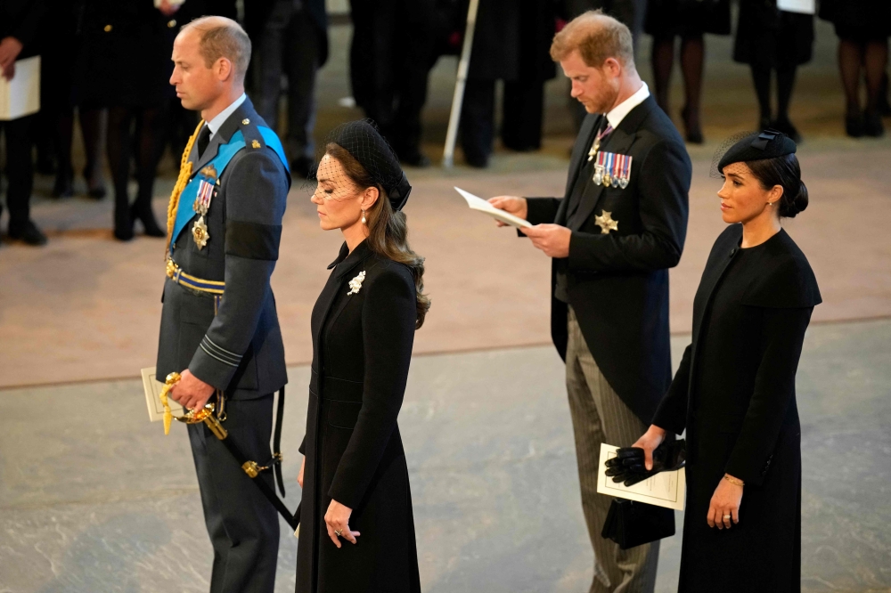 Britain's Prince William, Prince of Wales, Britain's Katharine, Duchess of Kent, Britain's Prince Harry, Duke of Sussex, and Meghan, Duchess of Sussex, stand after participating in the procession of the coffin of Queen Elizabeth II, to Westminster Hall, at the Palace of Westminster, in London. - AFP