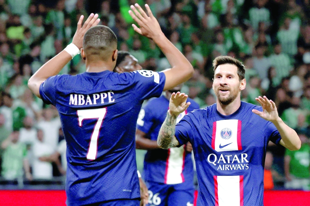 TOPSHOT - Paris Saint-Germain's Argentine forward Lionel Messi (R) celebrates scoring the equaliser with Paris Saint-Germain's French forward Kylian Mbappe during the UEFA Champions League group H football match between Israel's Maccabi Haifa and France's Paris Saint-Germain (PSG) at the Sammy Ofer stadium in the city of Haifa on September 14, 2022. (Photo by JACK GUEZ / AFP)

