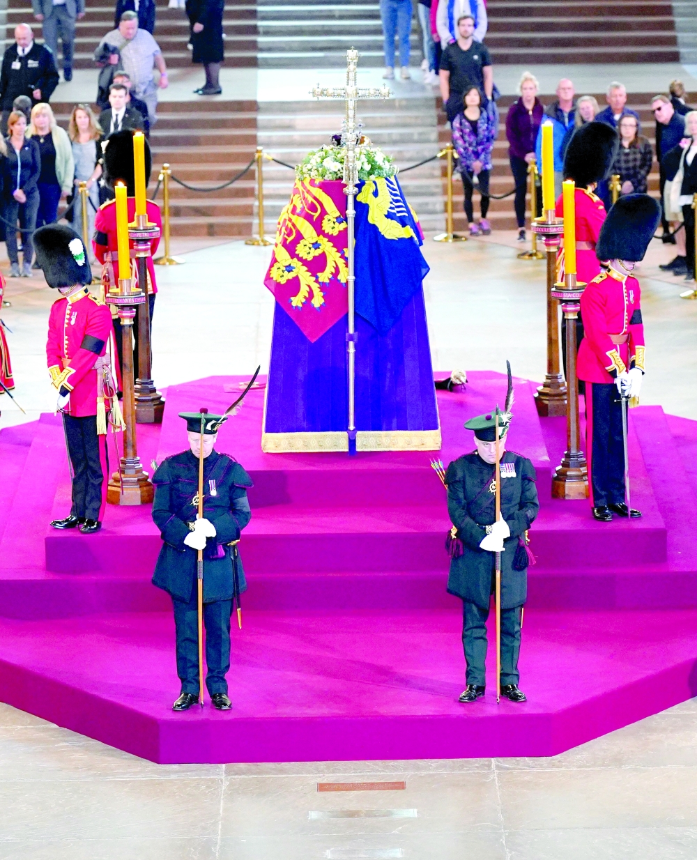 Scottish Secretary Alister Jack (front L) and Secretary of State for Defence Ben Wallace (front R) stand in ceremonial role as members of the Royal Company of Archers guard the coffin of Queen Elizabeth II as it lies in State inside Westminster Hall at the Palace of Westminster in London. -- AFP