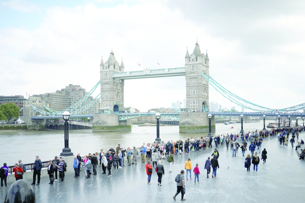 People queue near Tower Bridge to pay their respects to the late Queen Elizabeth II. -- Reuters