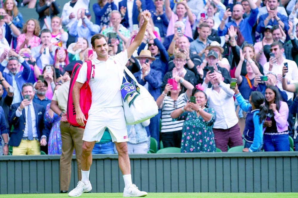 FILE PHOTO: Jul 7, 2021; London, United Kingdom; Roger Federer (SUI) waving farewell to the Centre Court fans after losing to Hubert Hurkacz (POL) in the quarter finals at All England Lawn Tennis and Croquet Club. Mandatory Credit: Peter van den Berg-USA TODAY Sports/File Photo
