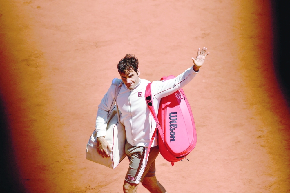 (FILES) In this file photo taken on June 7, 2019 Switzerland's Roger Federer acknowledges the audience after loosing against Spain's Rafael Nadal during their men's singles semi-final match on day 13 of The Roland Garros 2019 French Open tennis tournament in Paris. Swiss tennis legend Roger Federer is to retire after next week's Laver Cup, he said on September 15, 2022. (Photo by Philippe LOPEZ / AFP)

