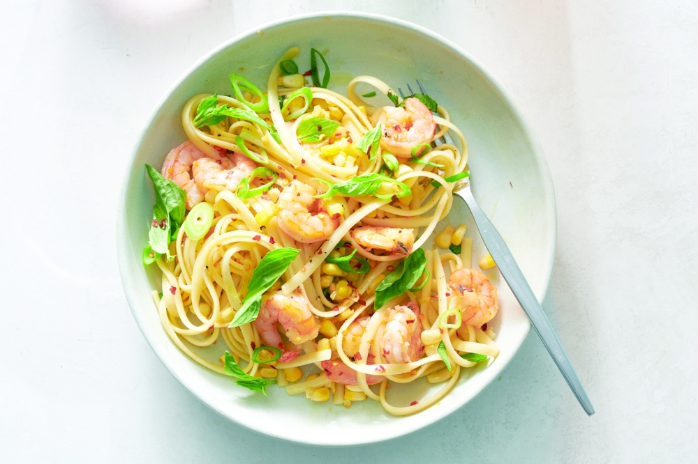 Bell pepper salad with capers and olives and shrimp pasta with corn and basil in New York, Aug. 31, 2022. Food styled by Greg Lofts. (David Malosh/The New York Times)
