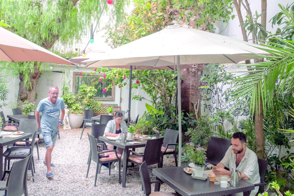 Patrons dine in the private garden at the Hotel Liberty in Sitges, Spain, in August 2022. (Maria Contreras Coll/The New York Times)