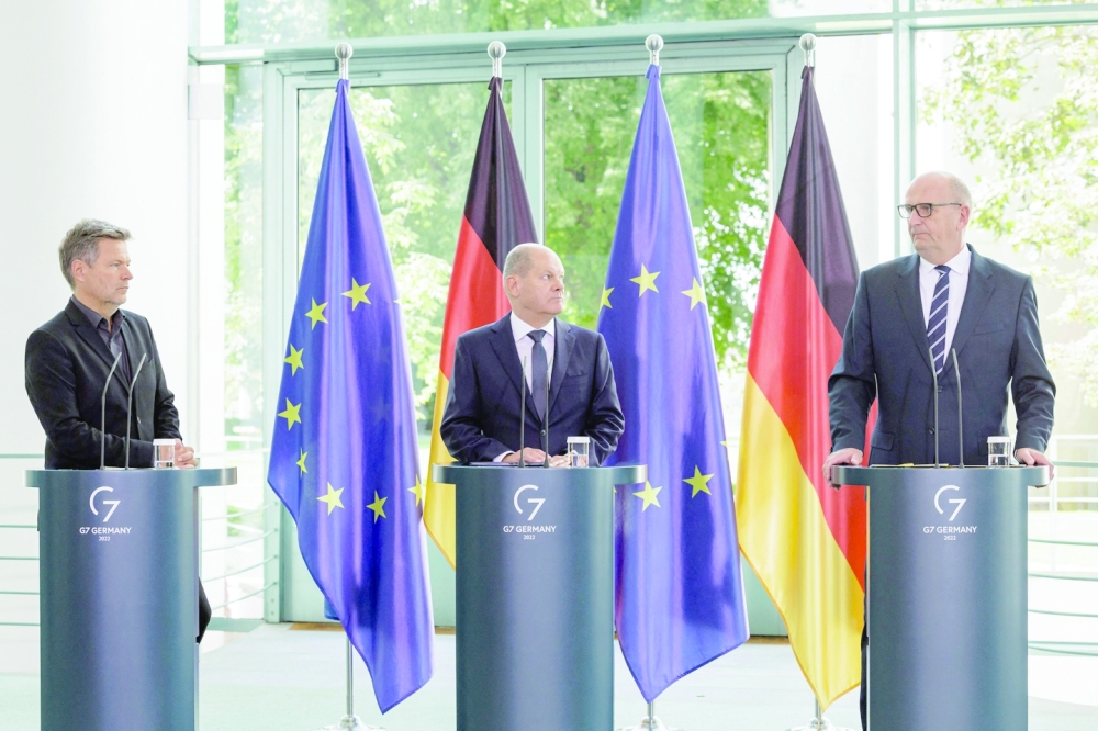 (From left) German Minister of Economics and Climate Protection Robert Habeck, German Chancellor Olaf Scholz and Brandenburg's State Premier Dietmar Woidke address a press conference on Friday at the Chancellery in Berlin, after the government announced it took control of the German operations of Russian oil firm Rosneft. - AFP