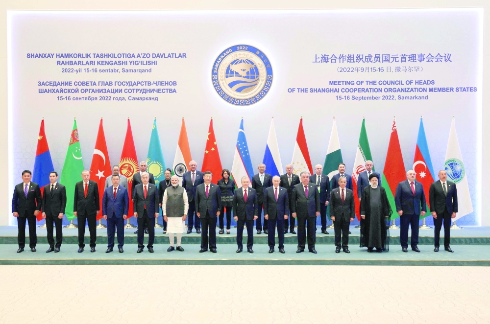 From left: Mongolian President Ukhnaa Khurelsukh, Turkmen President Serdar Berdymukhamedov, Turkish President Recep Tayyip Erdogan, Kazakh President Kassym-Jomart Tokayev, Indian Prime Minister Narendra Modi, Chinese President Xi Jinping, Uzbek President Shavkat Mirziyoyev, Russian President Vladimir Putin, Tajik President Emomali Rahmon, Pakistani Prime Minister Shahbaz Sharif, Iranian President Ebrahim Raisi, Belarusian President Alexander Lukashenko and Azerbaijani President Ilham Aliyev pose for a family photo before the meeting in an expanded format at the Shanghai Cooperation Organisation (SCO) leaders' summit in Samarkand on Friday. -- AFP