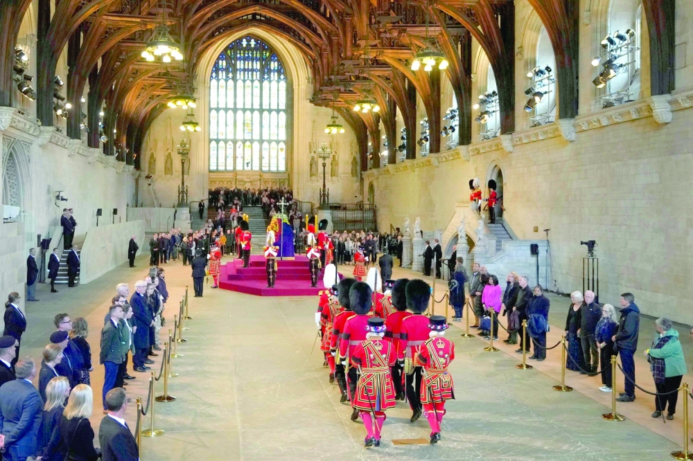 The King's Bodyguard the Yeomen of the Guard, members of the Scots Guards, and Gentlemen at Arms change guard duties by the coffin of Queen Elizabeth II as it Lies in State inside Westminster Hall. -- AFP