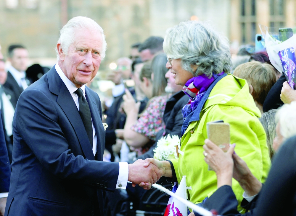Britain's King Charles interacts with people outside Cardiff Castle in Cardiff on Friday. — Reuters
