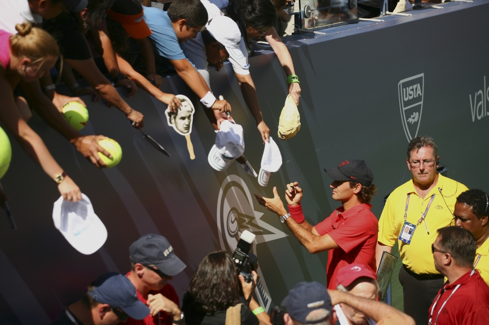 Tennis player Roger Federer signs autographs during Aurthur Ashe Kids’ Day, before the start of the US Open in New York, on Aug. 23, 2008. (Michael Nagle/The New York Times)
