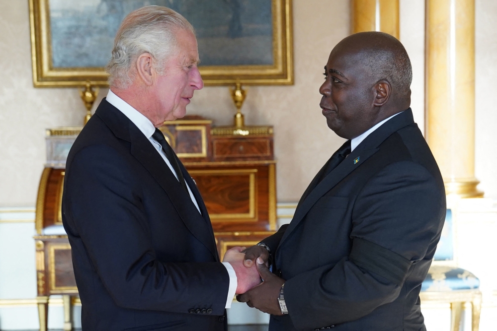 Britain's King Charles III (L) shakes hands with Philip Davis, Prime Minister of The Bahamas
