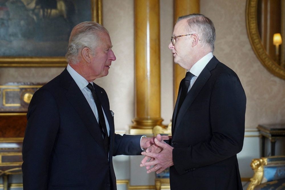 Britain's King Charles III (L) shakes hands with Anthony Norman Albanese, Prime Minister of Australia