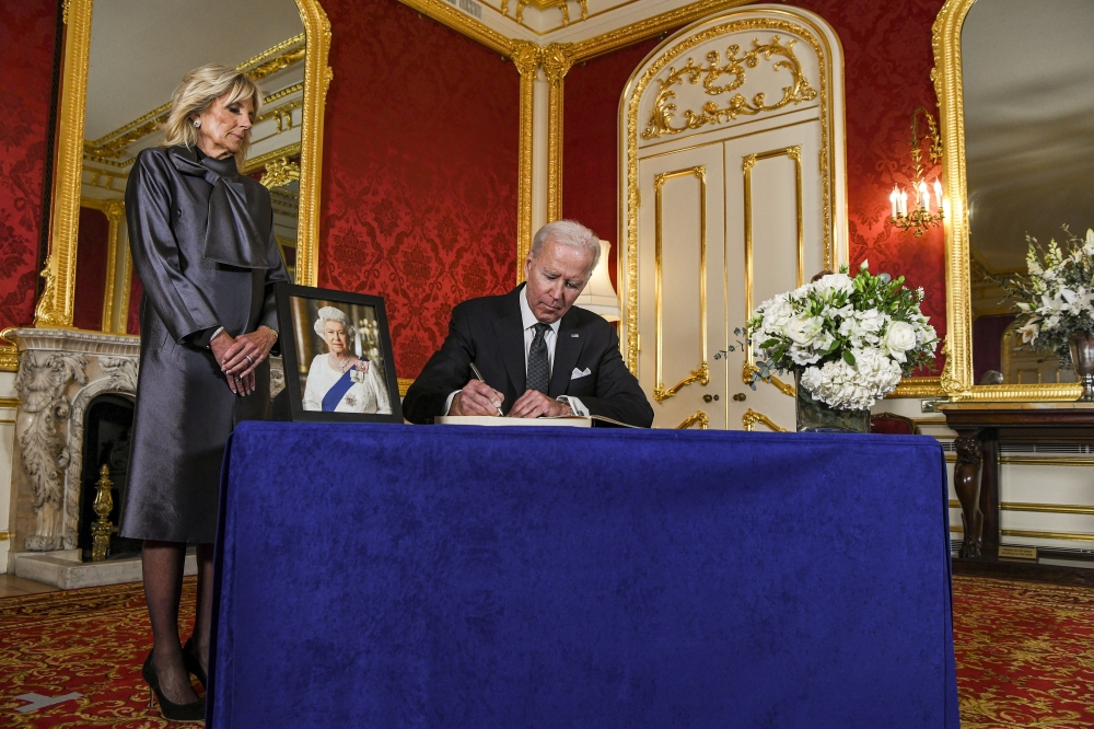 President Joe Biden signs the official condolence book for her majesty Queen Elizabeth II at Lancaster House in London, England, on Sept. 18, 2022. (Kenny Holston/The New York Times)