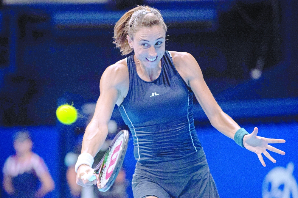 Petra Martic of Croatia hits a return against Rina Saigo of Japan during their women's singles match on day one of the Pan Pacific Open tennis tournament in Tokyo on September 19, 2022. (Photo by Philip FONG / AFP)

