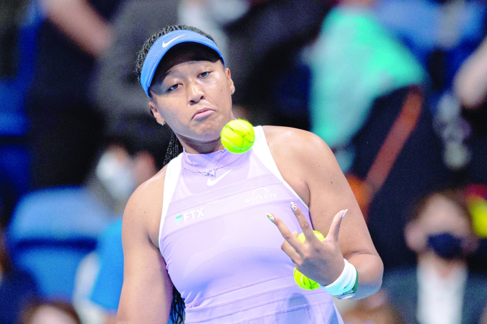 Naomi Osaka of Japan hits balls to the crowd after her victory against Daria Saville of Australia during their women's singles match on day two of the Pan Pacific Open tennis tournament in Tokyo on September 20, 2022. (Photo by Philip FONG / AFP)

