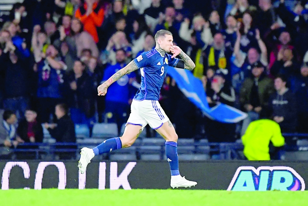 Scotland's striker Lyndon Dykes celebrates after scoring his second goal during the UEFA Nations League B Group 1 football match at Hampden Park stadium, in Glasgow, on September 21, 2022. (Photo by ANDY BUCHANAN / AFP)