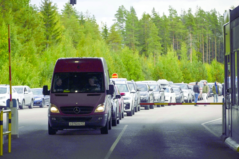 Cars coming from Russia wait in long lines at the border checkpoint between Russia and Finland near Vaalimaa. -- AFP