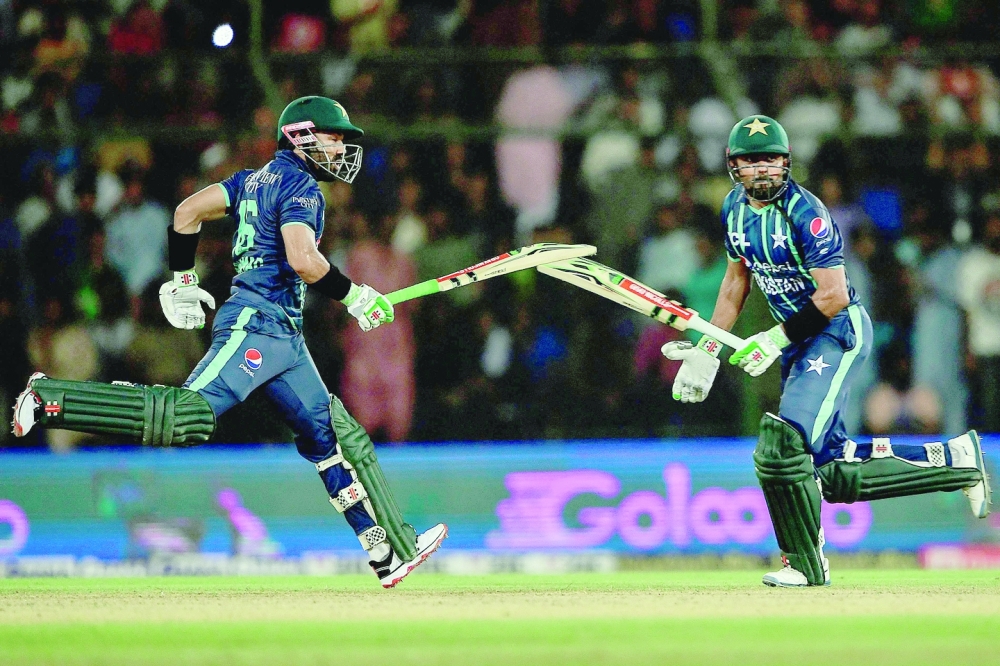 Pakistan's captain Babar Azam (R) and team-mate Mohammad Rizwan run between the wicket during the second Twenty20 international cricket match between Pakistan and England at the National Cricket Stadium in Karachi on September 22, 2022.  (Photo by Asif HASSAN / AFP)