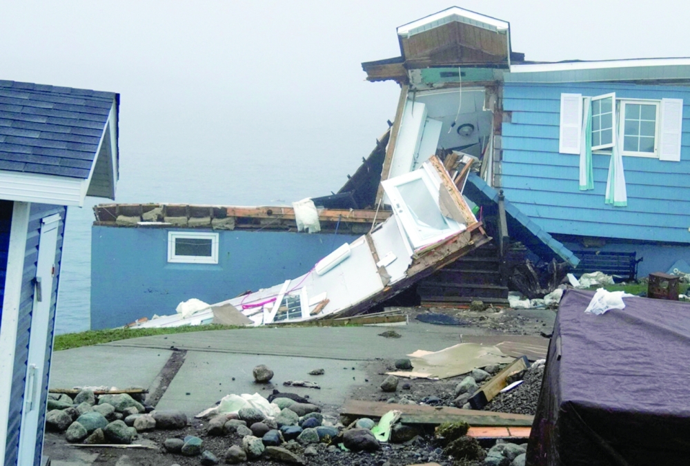 A view shows a damaged home in the aftermath of Hurricane Fiona in Port Aux Basques, Newfoundland, Canada. - Reuters