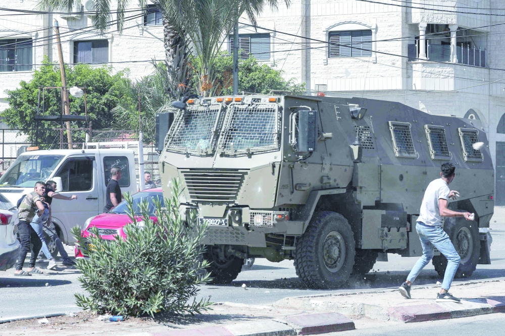 Israeli vehicles drive during a raid targeting alleged activists in Jenin, in the north of the occupied West Bank. - AFP
