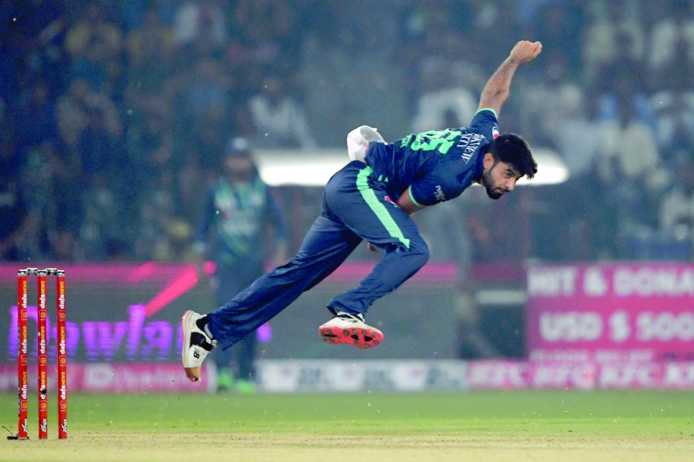 TOPSHOT - Pakistan's Aamer Jamal bowls during the fifth Twenty20 international cricket match between Pakistan and England at the Gaddafi Cricket Stadium in Lahore on September 28, 2022. (Photo by Aamir QURESHI / AFP)

