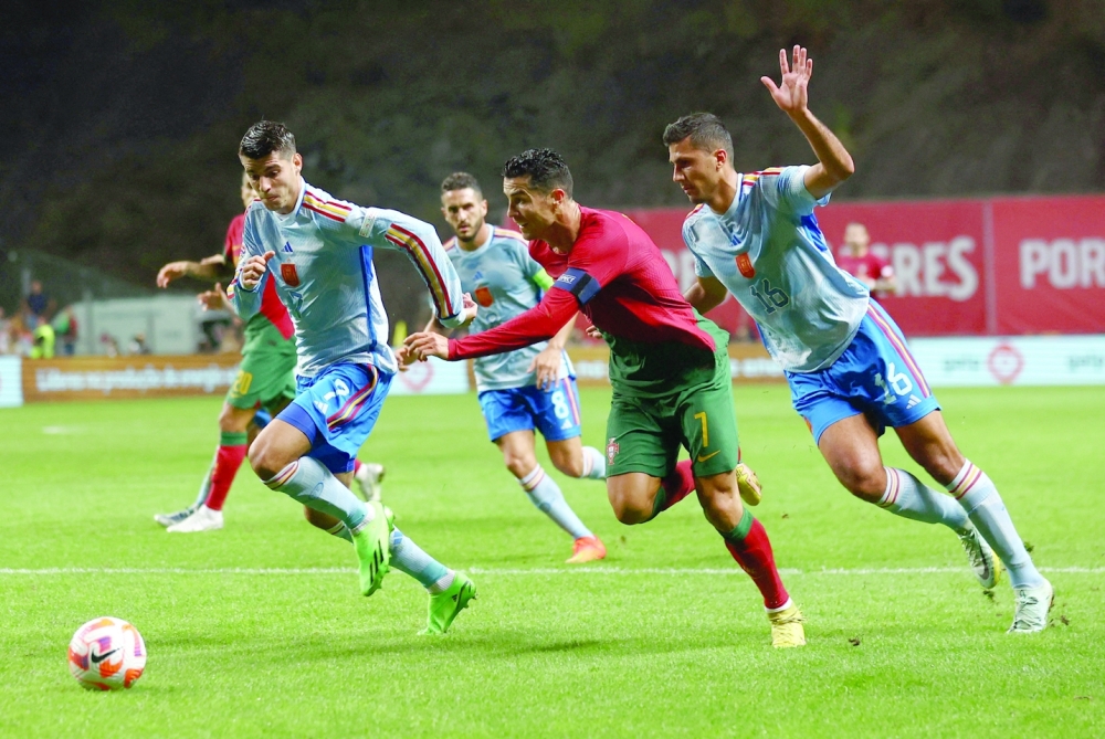 Soccer Football - UEFA Nations League - Group B - Portugal v Spain - Estadio Municipal de Braga, Braga, Portugal - September 27, 2022 Portugal's Cristiano Ronaldo in action with Spain's Alvaro Morata and Rodri REUTERS/Pedro Nunes
