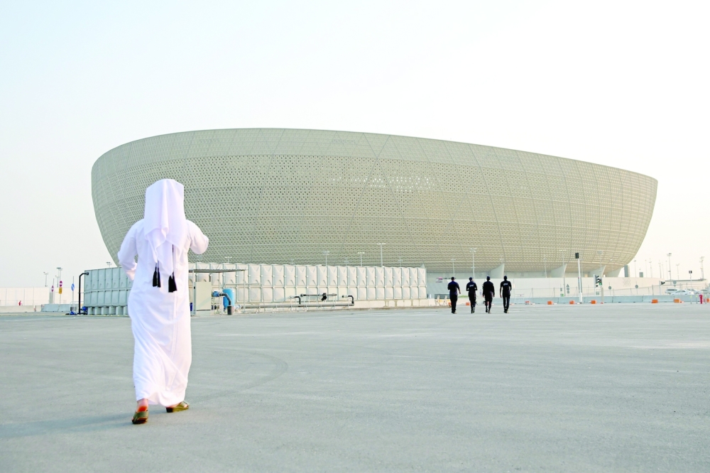 (FILES) This file photo taken on August 11, 2022, shows the Lusail Stadium, the 80,000-capacity venue which will host the FIFA World Cup final in December 2022, on the outskirts of Qatar's capital Doha. Eight stadiums will host the 2022 World Cup, which will take place from 20 November to 18 December in Qatar. Only one stadium existed before the country was designated as the World Cup host. (Photo by MUSTAFA ABUMUNES / AFP)

