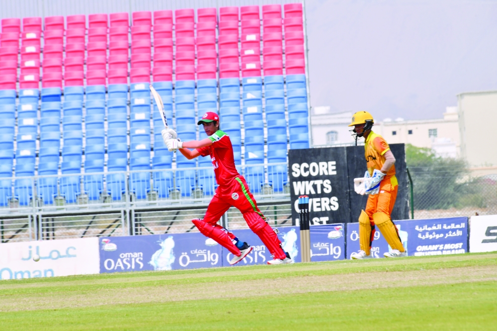 Oman batter Aryan Bisht plays a shot against Bhutan.