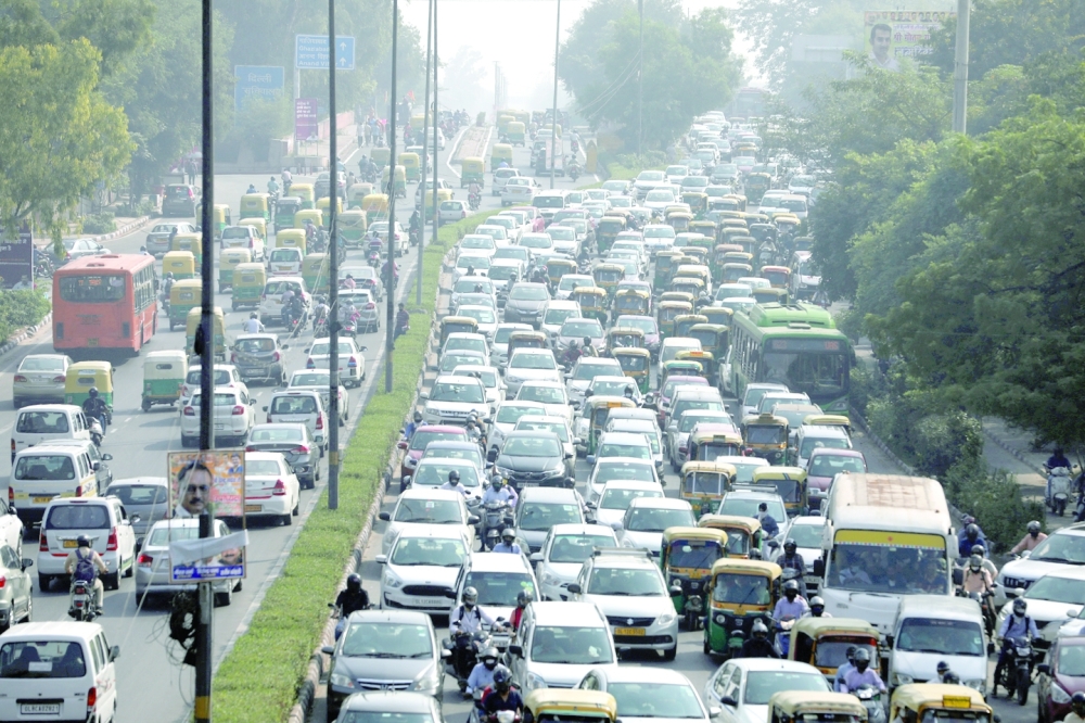 Vehicles queue at a traffic light on a hazy morning in New Delhi. -- Reuters
