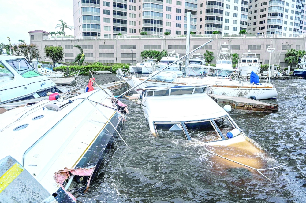 Boats are partially submerged at a marina in the aftermath of Hurricane Ian in Fort Myers, Florida. -- AFP