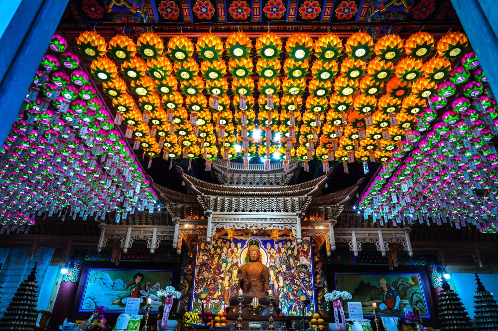 Buddha and lanterns at the 1,000-year-old Samhwasa, a temple in Donghae City, South Korea, Oct. 9, 2019. (Chang W. Lee/The New York Times)