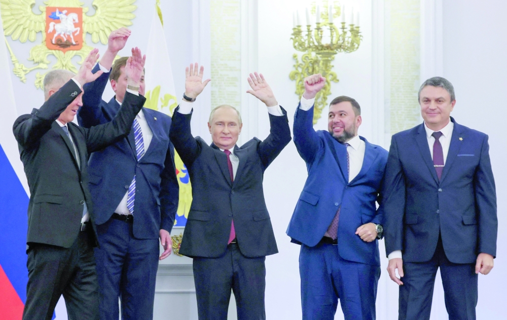 (L-R) The Moscow-appointed heads of Kherson region Vladimir Saldo and Zaporizhzhia region Yevgeny Balitsky, Russian President Vladimir Putin, Donetsk separatist leader Denis Pushilin and Lugansk separatist leader Leonid Pasechnik after signing treaties formally annexing four regions at the Kremlin in Moscow. -- AFP