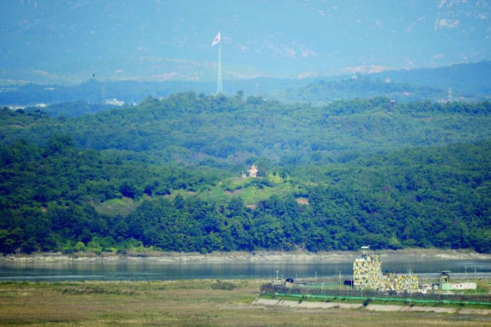 South and North Korean guard posts face each other as a South Korean national flag flutters in this picture taken from the Unification Observation Platform, near the demilitarised zone which separates the two Koreas in Paju, South Korea, on Thursday. - Reuters