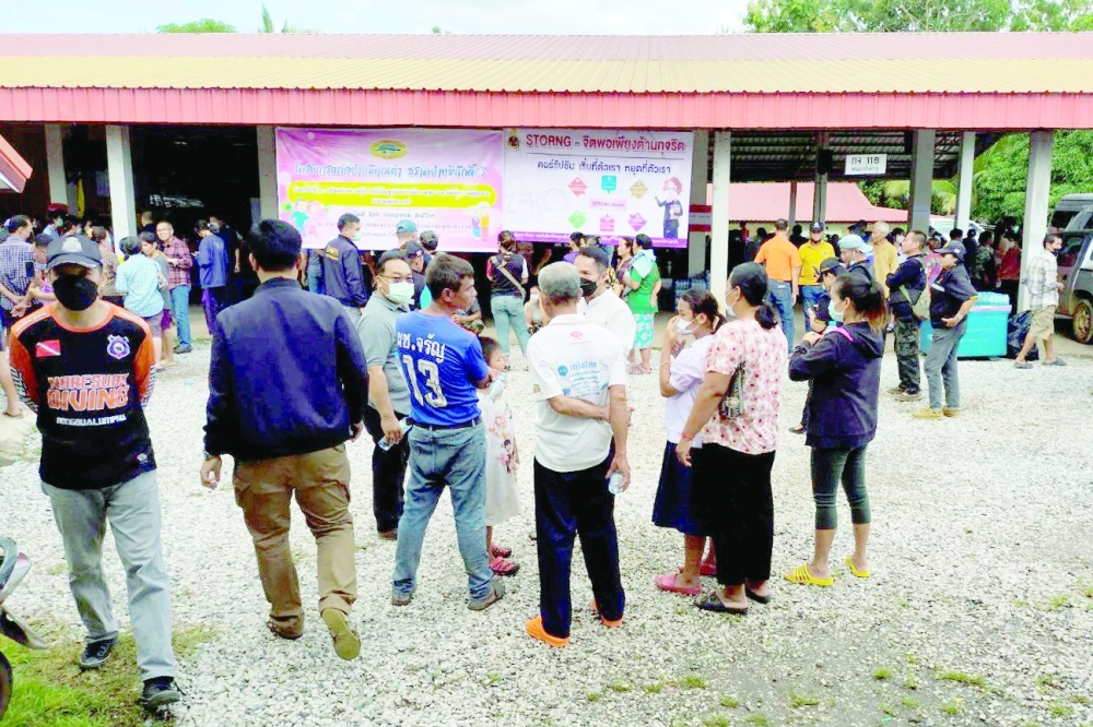 People gather outside of a daycare centre's scene of a mass shooting in the town of Uthai Sawan, 500 km northeast of Bangkok on Thursday. - Reuters