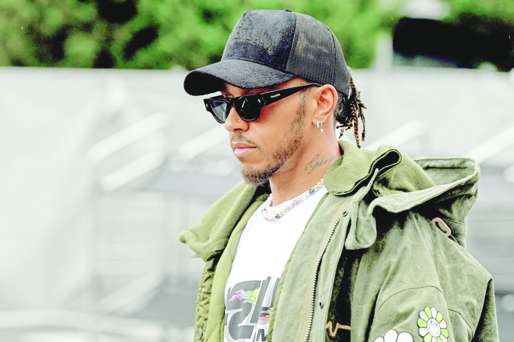 Mercedes’ Lewis Hamilton walks through the paddock ahead of the F1 Japanese Grand Prix in Suzuka. — AFP