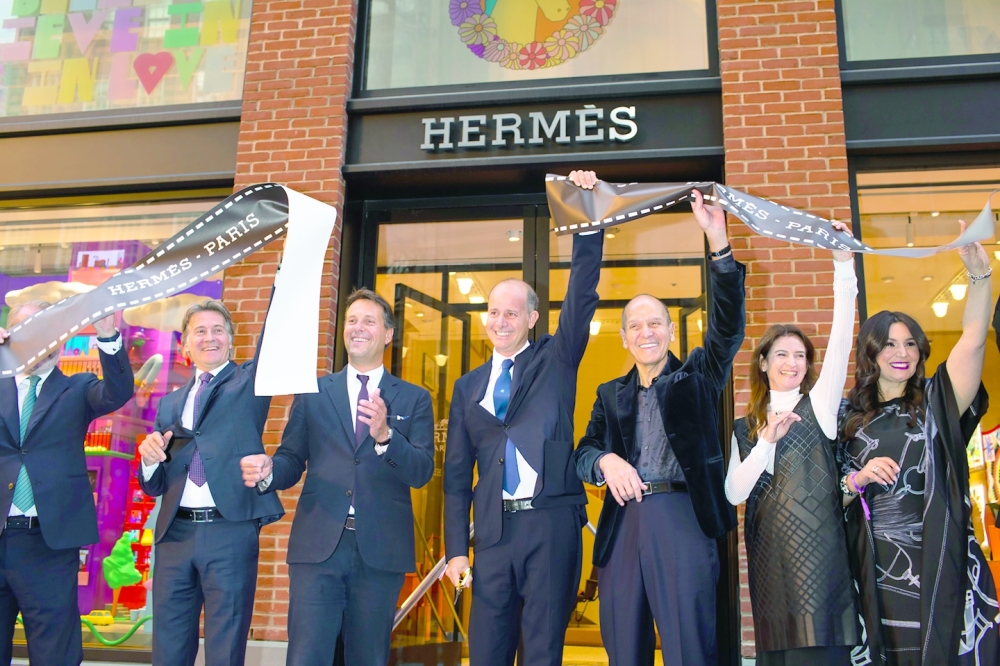 Pierre-Alexis Dumas, center, the brands artistic director and the great-great-great grandson of Thierry Herms, who founded the company in 1837, at the opening of the new Herms flagship store in Manhattan, Sept. 29, 2022. (Landon Nordeman/The New York Times)