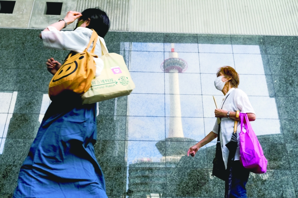 A reflection of Kyoto Tower in the glass walls of Kyoto Station in Kyoto, Japan, on Aug. 29, 2022. (Andrew Faulk/The New York Times)