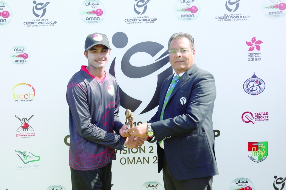 Singapore’s Adwitya Bhargav receives the man of the match award from Manu Nayyar, ICC tournament referee.
