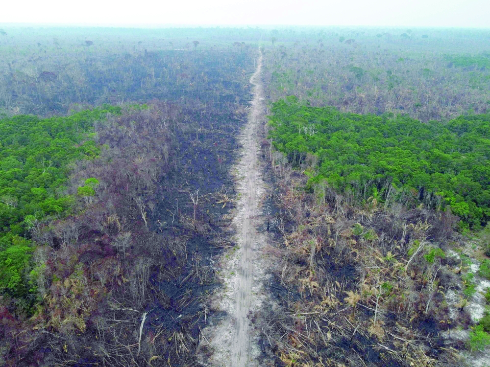 An aerial view of a deforested and burnt area on the edge of the BR-230 (Transamazonica) highway in Manicoré, Amazonas state, Brazil. -- AFP