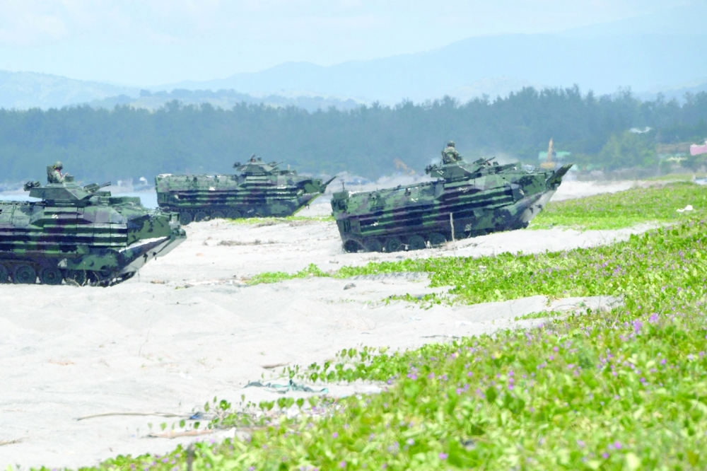 Philippine Marines amphibious assault vehicles roll in during a joint amphibious landing exercise with US marines at a beach facing the South China Sea in San Antonio town. -- AFP
