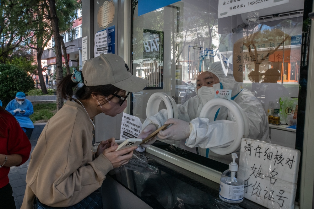 A woman registers for a COVID test at a temporary site in Beijing, Sept. 23, 2022. (Gilles Sabri