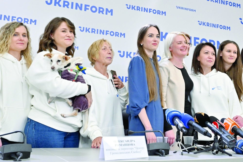 A team of the Ukraine's Center for Civil Liberties poses for media during their press-conference in Kyiv. - AFP 
