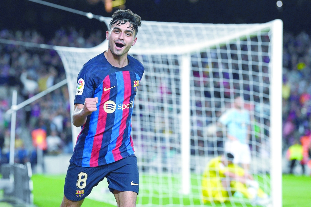 Barcelona's Spanish midfielder Pedri celebrates scoring the opening goal during the Spanish League football match between Barcelona FC and RC Celta de Vigo at the Camp Nou stadium in Barcelona on October 9, 2022.  (Photo by Josep LAGO / AFP)

