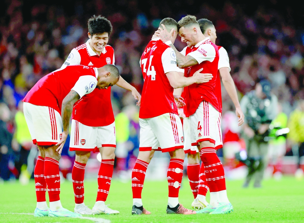 Soccer Football - Premier League - Arsenal v Liverpool - Emirates Stadium, London, Britain - October 9, 2022  Arsenal's Ben White, Granit Xhaka, Gabriel and Takehiro Tomiyasu celebrate after the match Action Images via Reuters/Peter Cziborra EDITORIAL USE ONLY. No use with unauthorised audio, video, data, fixture lists, club/league logos or 'live' services. Online in-match use limited to 75 images, no video emulation. No use in betting, games or single club /league/player publications.  Please contact your account representative for further details.