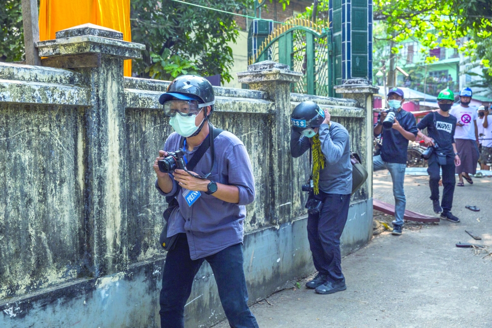 Journalists covering a protest near Yangon, Myanmar.
