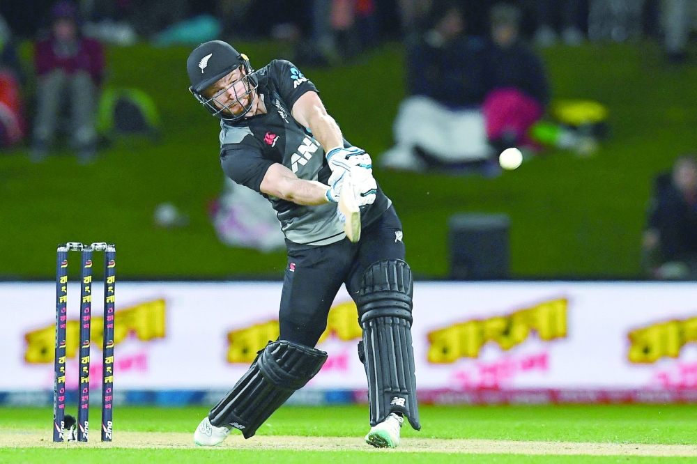 New Zealand's Glenn Phillips hits over the boundary line for six runs during the third cricket match between New Zealand and Bangladesh of the Twenty20 tri-series at Hagley Oval in Christchurch on October 9, 2022. (Photo by Sanka Vidanagama / AFP)

